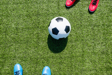 Soccer football background. Soccer ball and two players standing on artificial turf soccer field...