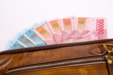 Indonesian rupiah money in brown wallet isolated on white background