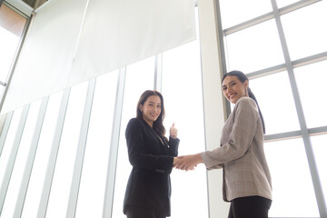 Handshake image of young businesswoman congratulating after successful business dew , Negotiation concept.