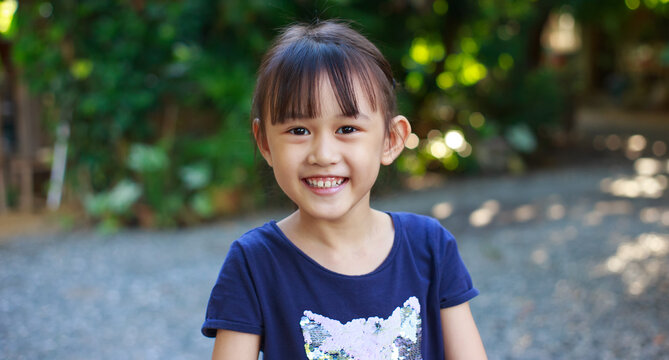 Portrait of little school girl smiley and happy face . Preschool kid looking attractive creative cheerful for back to school concept.
