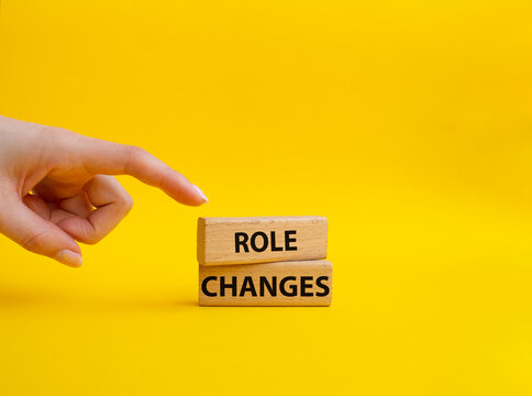 Role changes symbol. Concept words Role changes on wooden blocks. Beautiful yellow background. Businessman hand. Business and Role changes concept. Copy space.