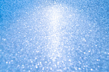 Christmas blue glowlight blur bokeh abstract background.concept happy holiday new year festive glitter backdrop.
