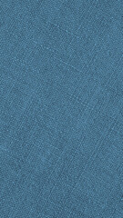 Blue woven surface close up. Linen braided textile texture. Fabric net vertical background. Textured len phone wallpaper. Macro