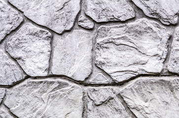 Textured background of natural stone wall. Beige stone wall.