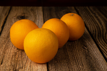 Oranges on a wooden background. An icon for a store for selling oranges.