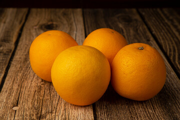 Oranges on a wooden background. An icon for a store for selling oranges.