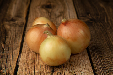 Onions on a wooden background. Icon for a store for the sale of onions.