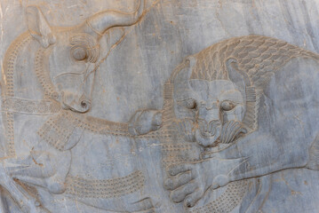 Bas-relief decoration along stairs from Darius palace to Palace of Xerxes. Ancient ruins of Persepolis near Shiraz in southern Iran. This UNESCO World Heritage Site showcases beautiful ruins from the 