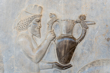Bas-relief decoration along stairs from Darius palace to Palace of Xerxes. Ancient ruins of Persepolis near Shiraz in southern Iran. This UNESCO World Heritage Site showcases beautiful ruins from the 