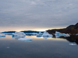 The iceberg filled waters of the Tunulliarfik and Sermilik Fjords on the shores of the port...