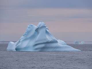 Navigating among gigantic icebergs along the Western coast of Greenland during the midnight sun