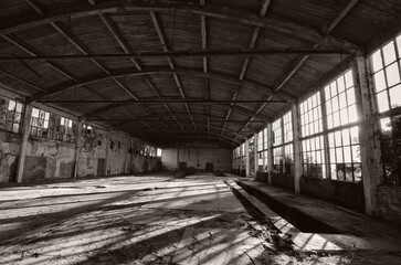 Old abandoned factory building or warehouse on a sunny summer day