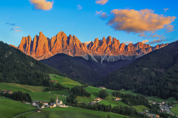St. Magdalena village with magical Dolomites Odle mountain ridge in golden hour of sunset with...