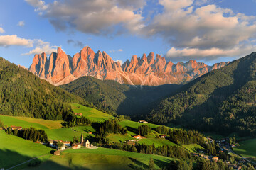 Afterglow over the Odle Ridge in the idyllic Dolomites mountains village St Madgalena, Val di...