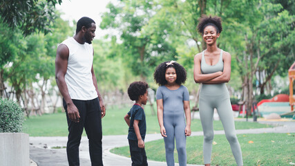 Obraz premium African children and families happily play outdoor sports in the garden.Man jogging with nature in the garden.On summer vacation, the family happily took a walk in nature.
