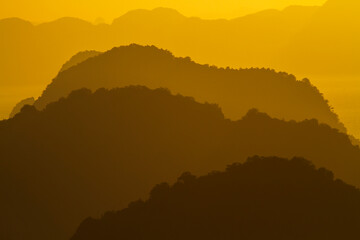 Mountain silhouette with golden sunlight. Beautiful landscape of the nature.