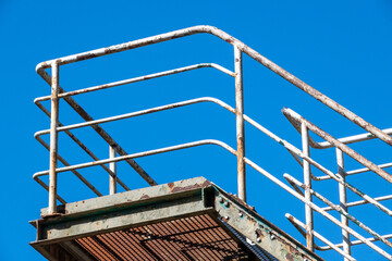 rusty railing with blue background