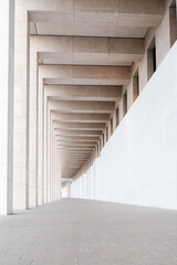 Corridor in perspective in Doha, Qatar with bright sunlight: simple geometric background, modern minimal concept