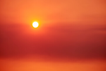 A big red sun in the sunset sky, a summer landscape. Evening sky in hot sunlight