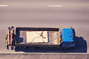Truck body with concrete slab during road repair, top view