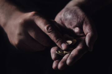 Man hands holding rubles money on a black background, close-up. Russian cash in the dirty hands of a poor man on a dark background