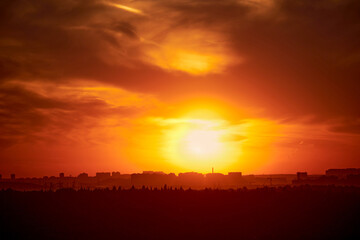 Evening sky with setting sun through clouds at sunset, cloudy landscape