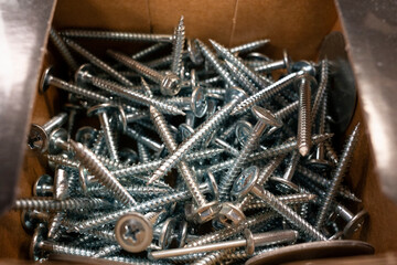 Top view of bolts and nuts that lie in their boxes.