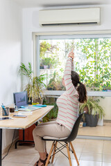 Young businesswoman stretching in office. Workplace fitness.