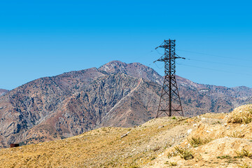 Metal support of a high-voltage power transmission line in the mountains