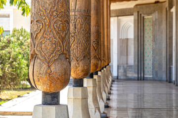 Row of carved wooden columns ustum in Bukhara