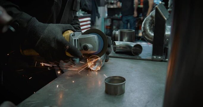 Worker Cutting Steel. Cutting Iron Elbows