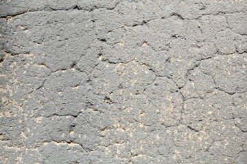 Old foundation crack concrete cement surface grey wall texture background. Design pattern of wall with paint beige spots. Architecture grunge modern abstract style element. Close-up, copy space