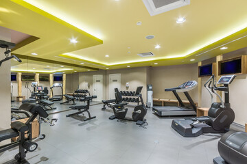 Fototapeta na wymiar A spacious, bright gym in the wellness center with a variety of sports equipment.