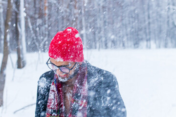 Fototapeta na wymiar portrain of indian man in red hat with throwing snow on his face
