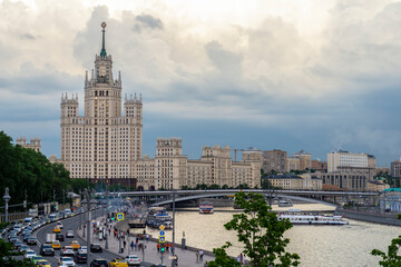 Fototapeta na wymiar Moscow, Russia - June 2022: View of the high-rise Stalinist building on the Kotelnicheskaya embankment and the Moskva river in the evening