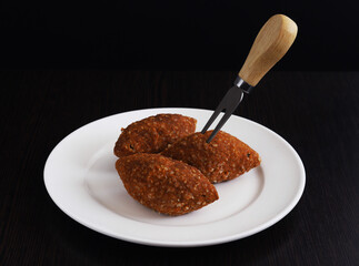 Ishli kufta. Beef kufta from lentils and bulgur. They went kyufta on a fork. Close-up