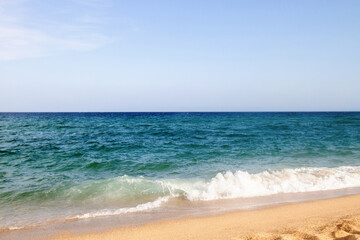 Waves, sea, beach, clear water. Bridge in the water.