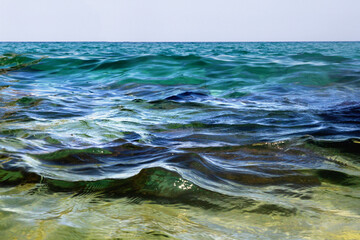 Waves, sea, clear water. Stones under water. Spain.