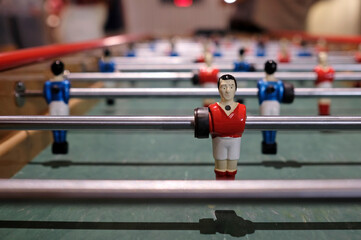 Figurine of an extra-long foosball table or table football