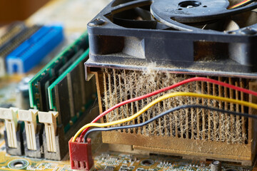 Old motherboard covered in dust and dirt. Close-up.