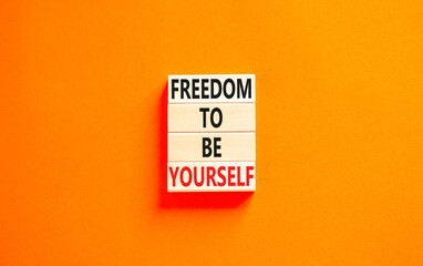 Freedom to be yourself symbol. Concept words Freedom to be yourself on wooden blocks on a beautiful orange table orange background. Business, psychological freedom to be yourself concept.