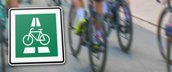 new german traffic sign indicating prioritized bicycle highway in front of a blurred background...