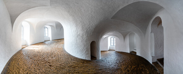 Panorama of the interior of  Round Tower (Rundetaarn), a 17th-century tower built as an astronomical observatory in the center of Copenhagen, Denmark with a brick spiral ramp staircase