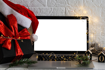 Blank display screen laptop computer. Modern cozy comfortable home living room with Christmas decor. Home office desk workspace