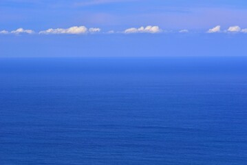 The immense Ocean merges with the sky on the horizon
