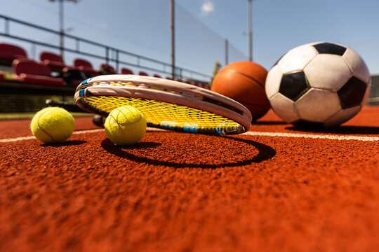 Set of sport equipment, rackets and tennis balls soccer and basketball balls - Powered by Adobe