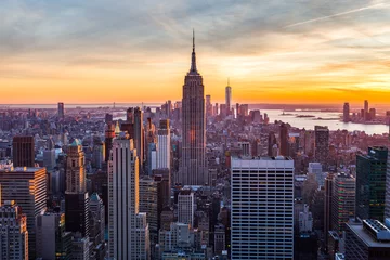 Fotobehang De Stadshorizon van New York bij zonsondergang © norbel