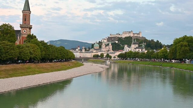 Salzburg, Austria, August 2022. Golden hour tilt footage in the direction of the Old Town. In evidence the fort on top of the hill that dominates the landscape.