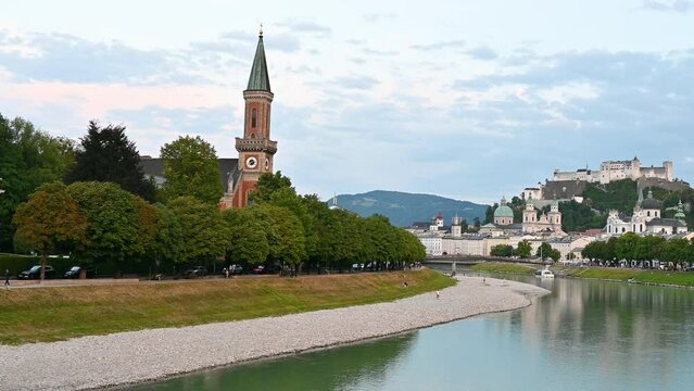 Salzburg, Austria, August 2022. Golden hour pan footage in the direction of the Old Town. In evidence the fort on top of the hill that dominates the landscape.