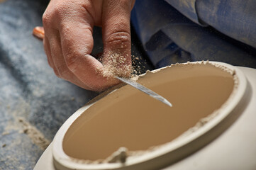 Craftsman molding a clay vase